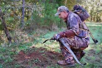 man outdoors on a hunt with archery