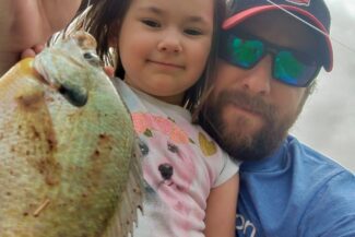 father and daughter with fish