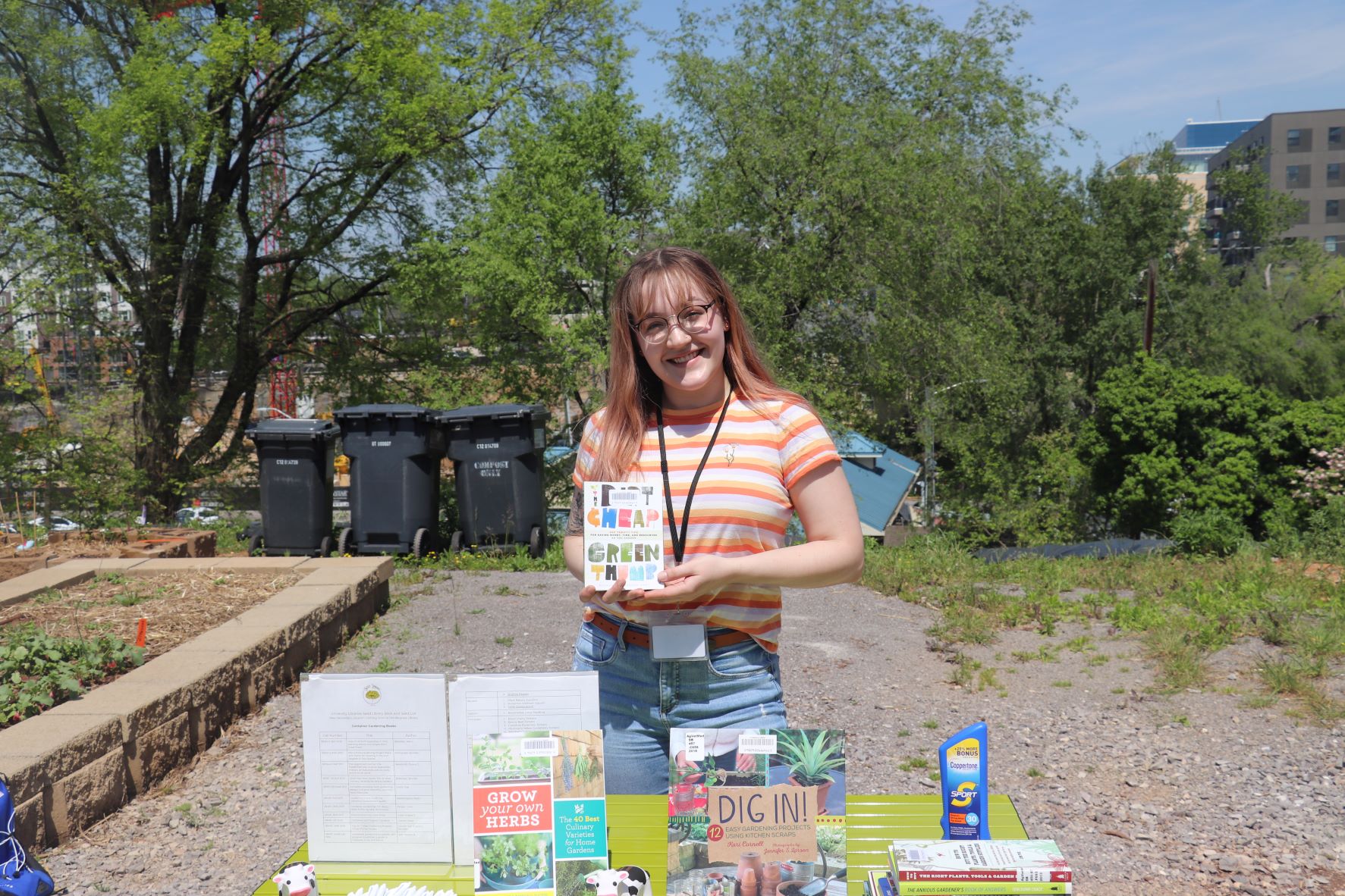 Kay holding a book infront of programming table