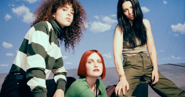 MUNA, three young women looking directly into the camera.