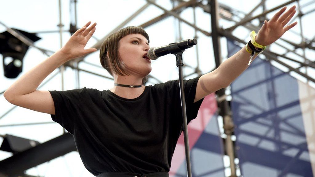 Katie Gavin singing at an outdoor concert.