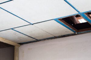 Close-up of a hole in the ceiling of an old house that was removed from a termite-eaten timber frame, prepared for renovation.
