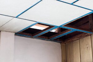 Close-up of a hole in the ceiling of an old house that was removed from a termite-eaten timber frame, prepared for renovation.
