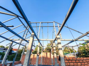 House construction site Use red bricks as a wall. With steel roof frame Concrete pillar.