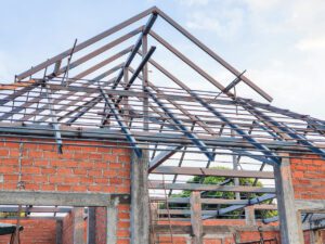 House construction site Use red bricks as a wall. With steel roof frame Concrete pillar.